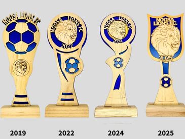 Wooden trophies with Noosa Lions FC and soccer ball designs from 2019 to 2025.
