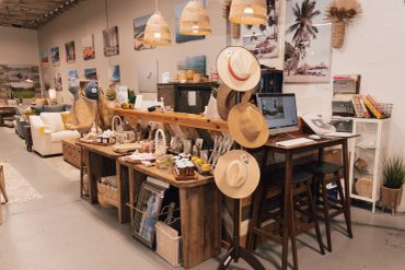 Cozy boutique with hats and artisanal goods on rustic wooden displays.