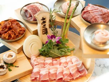 Assorted fresh meats and vegetables artfully arranged for hot pot.