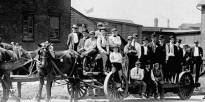 horse and moving cart
old photo of men and horse and moving cart
black and white photo
carriage