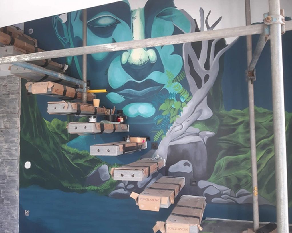 Wall mural with floating wooden shelves and scaffolding.