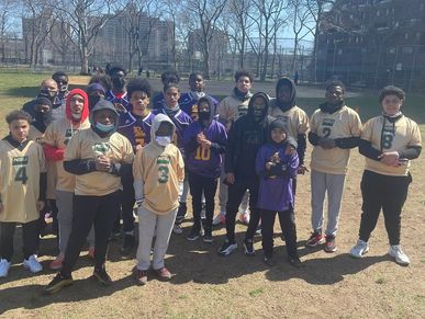 Group of young athletes posing outdoors.