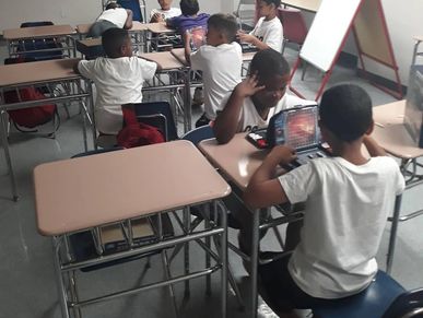 Children using tablets in a classroom.