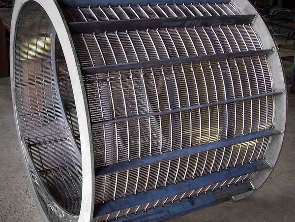 Large cylindrical metal sieve or rotary drum screen with mesh sides.