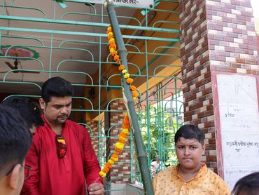 A man and boy near a decorated pole.