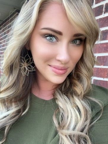 Young woman with blonde hair smiling.