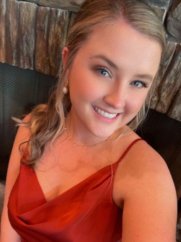 Smiling woman in a red dress.
