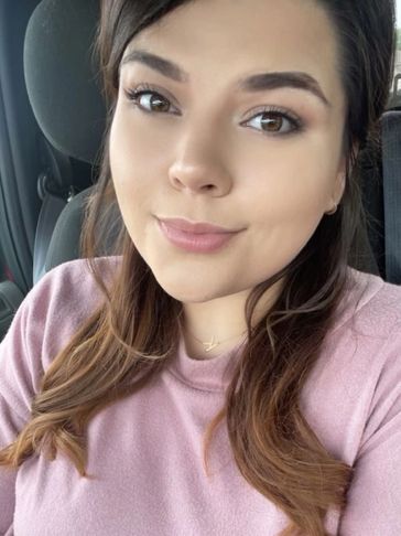 Young woman taking a selfie in a car.