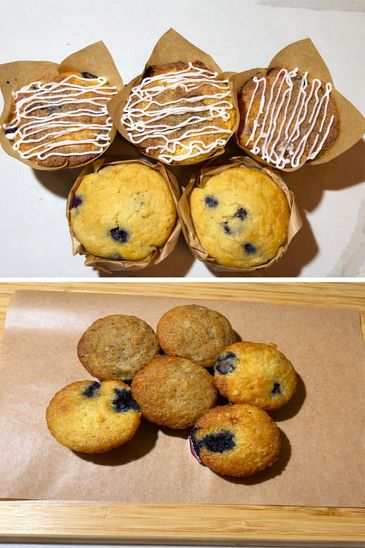 Blueberry muffins with and without icing, freshly baked and displayed on parchment paper.