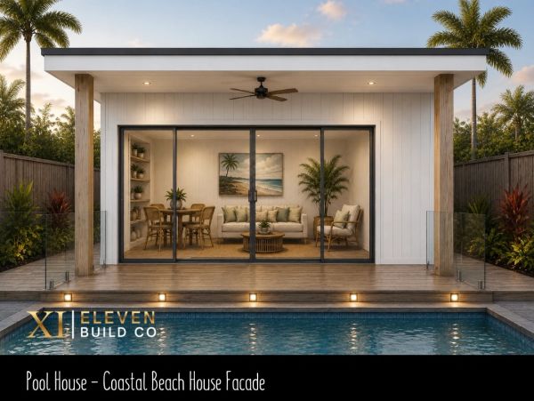 Modern pool house with glass doors and coastal decor.