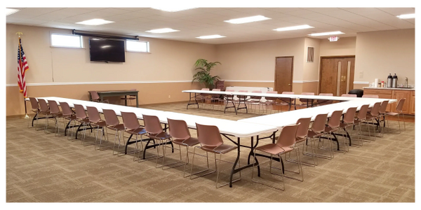 Picture of a large conference room with tables and chairs
