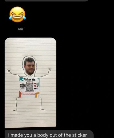 A sticker with a face and a drawn stick figure body.