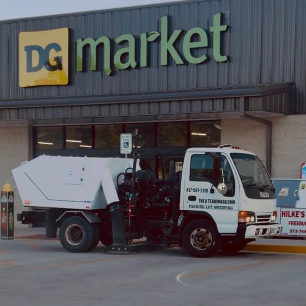Vacuum sweeper clearing debris from parking lot in Ozark Missouri