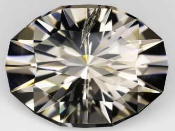 A close-up of a faceted, clear gemstone reflecting light.