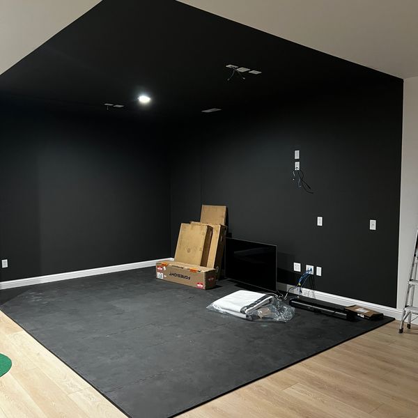 In-progress custom golf simulator installation designed from scratch for a residential space in the 