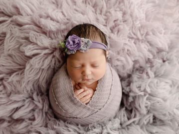 newborn baby girl in purple 