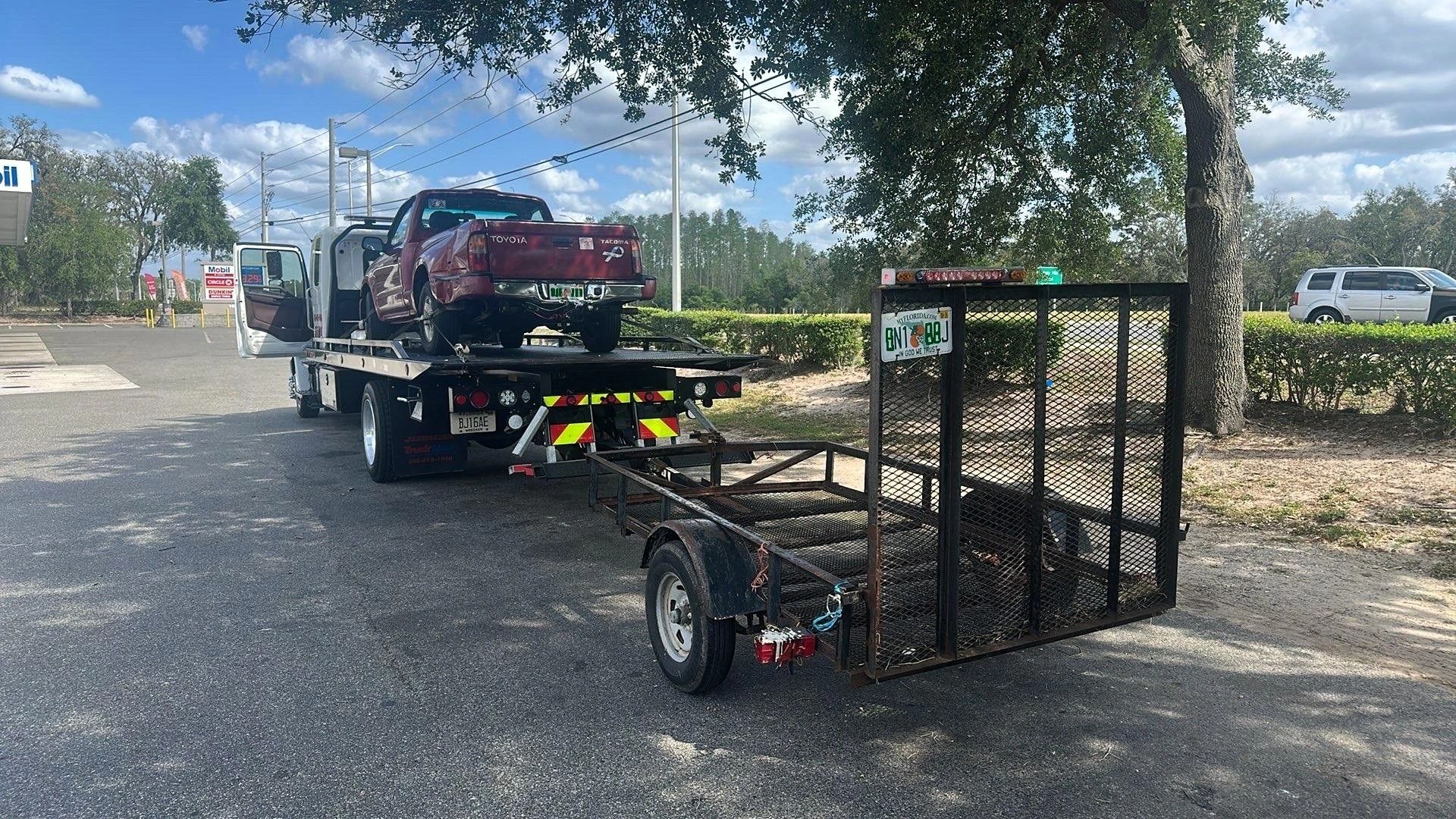 TP Towing flatbed tow truck with small pickup truck and trailer 