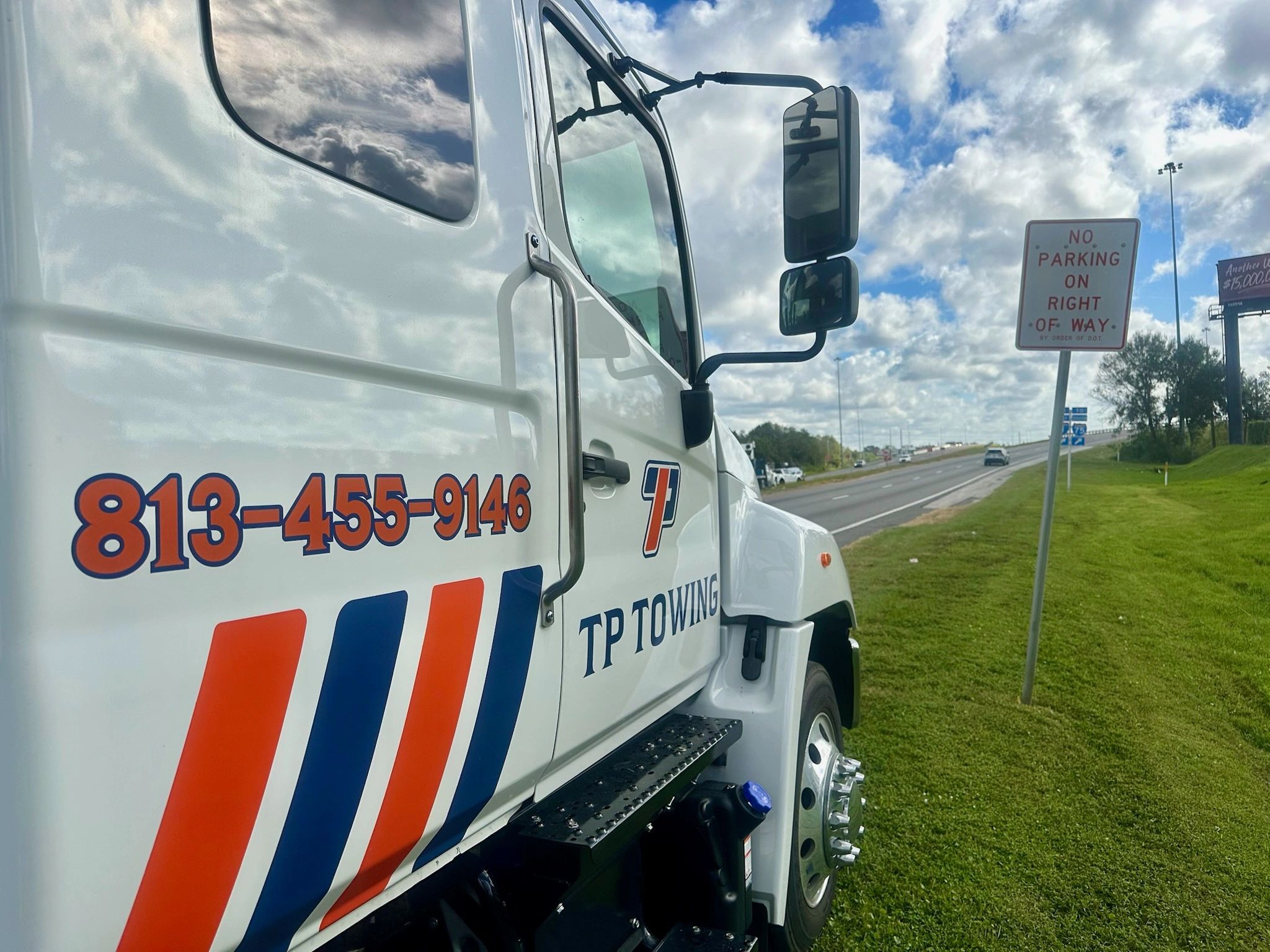 Side-facing tow truck photo with TP Towing branding