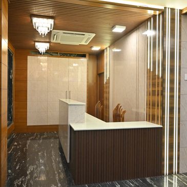 Modern reception area with marble counters and wood paneling.