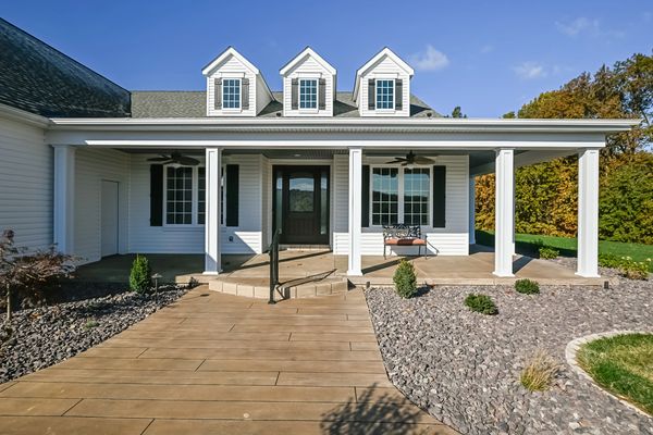 Front exterior of home with front porch and dormers visible