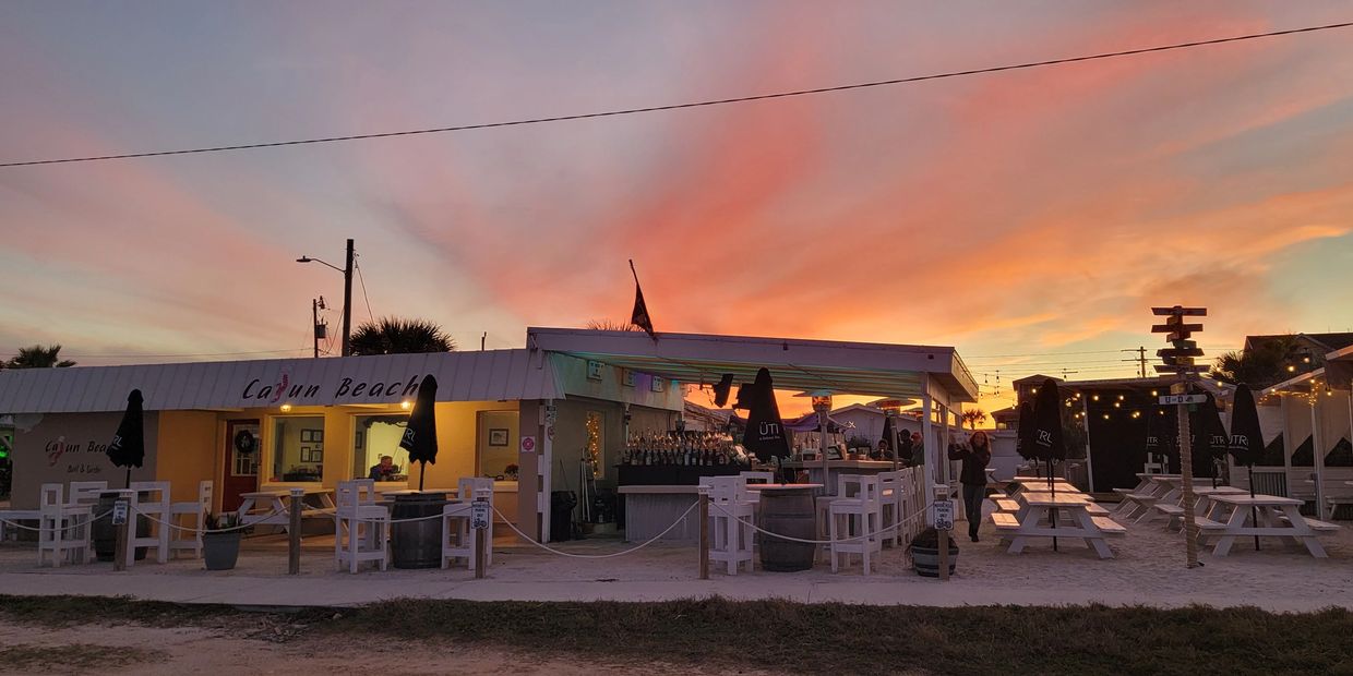The cajun beach in the evening with the sun going down and the sky beautiful coastal colors