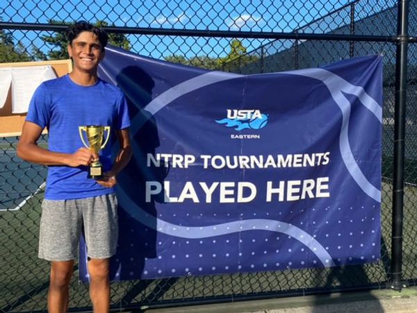 Pratik holding a trophy of an L6 victory