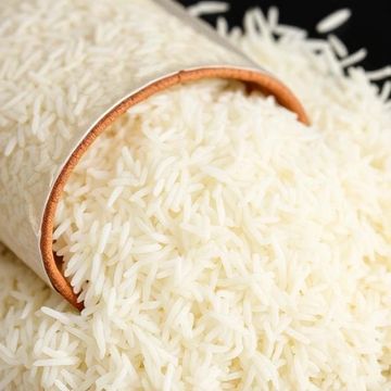 Close-up of white rice spilling from a container.