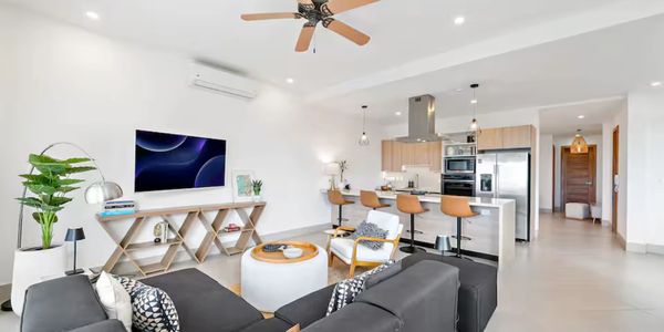 Modern open-concept living room with kitchen and stylish furniture.