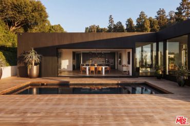 Modern house with a pool and wooden deck.