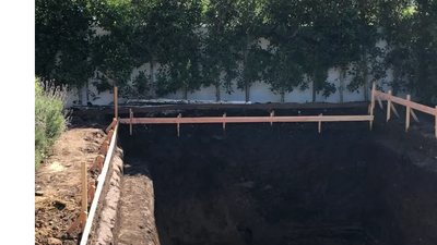 Excavated hole for future swimming pool.
