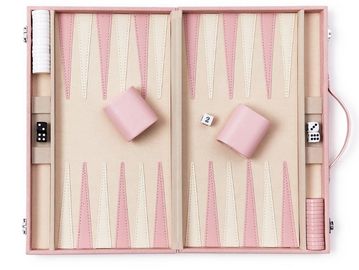 Pink and beige backgammon set with dice and cups.