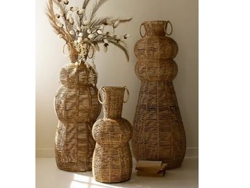 Three woven wicker vases of varying sizes.