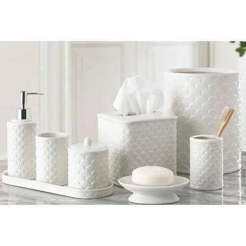 White ceramic bathroom accessory set with textured design.