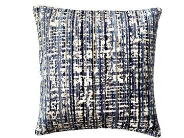 Square decorative pillow with blue and white abstract pattern.