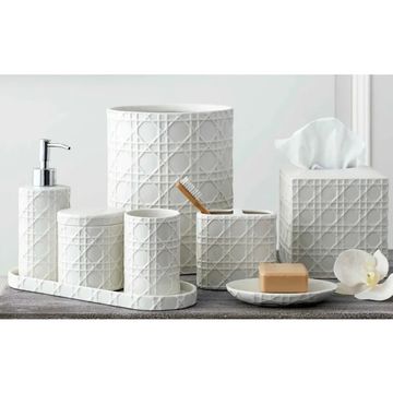 White bathroom accessories set with geometric pattern.