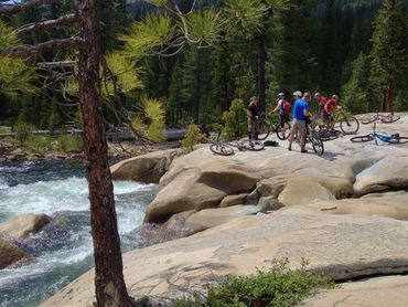 Mountain bikers taking a break along Fordyce Creek. Photo by Jeff Barker