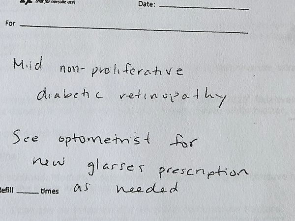 Handwritten medical notes about diabetic retinopathy and glasses prescription.