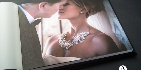 A wedding photo album page showing a couple about to kiss.
