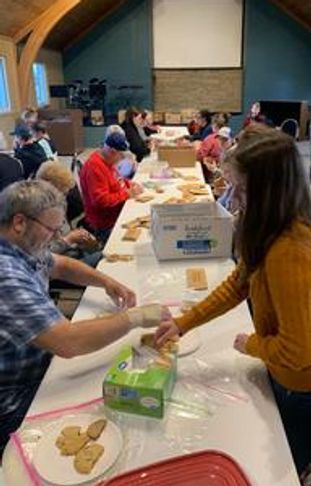 Church members serving and packing items for an outreach activity