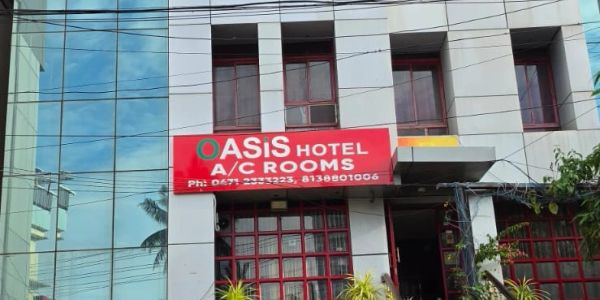 Hotel Oasis signboard on a building.