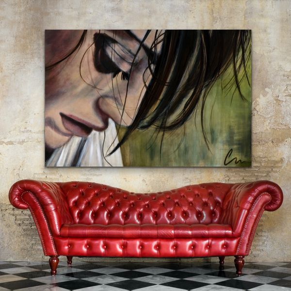 WOMAN LOOKING DOWN OVER A RED COUCH