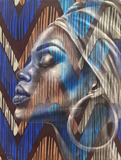 Profile of a woman with closed eyes, adorned with a headwrap and large hoop earrings against a patterned background.