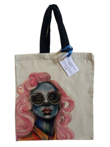 Canvas tote bag with colorful portrait of a woman with pink hair and sunglasses.