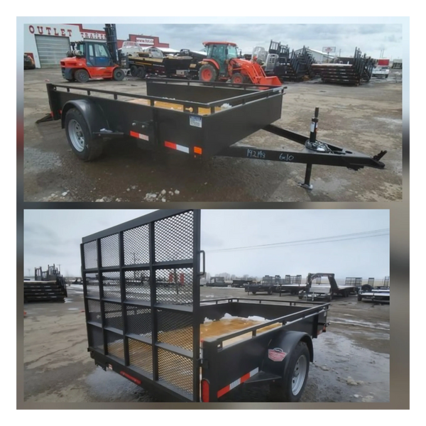 Black utility trailer with mesh ramp gate in an outdoor lot.