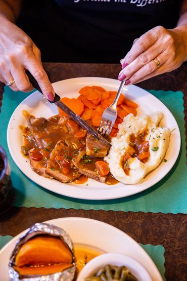 A person slicing meat