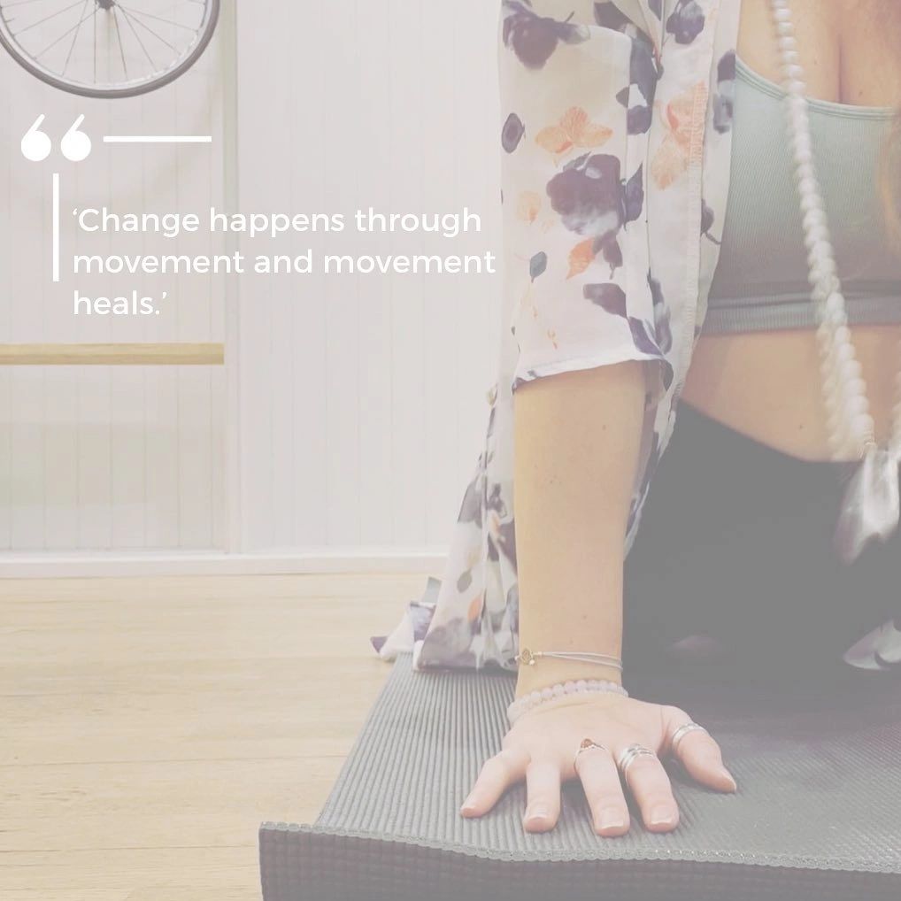 Woman practicing yoga with an inspiring quote on movement and healing.