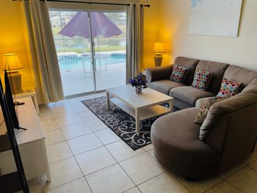 Florida Vacation Villa. Open plan seating area overlooking the pool & natural lake.