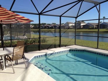 Florida Vacation Villa. The fully enclosed 30 foot heated pool over looks the beautiful lake. 