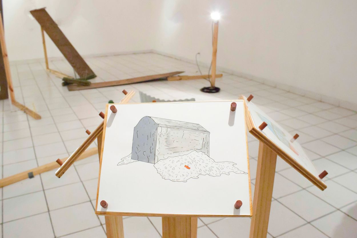 Art installation featuring wooden frames and a drawing of a bread loaf melting.