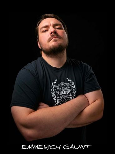 Confident man with crossed arms against a black background.